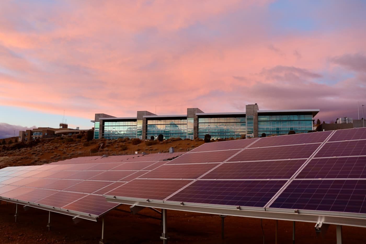 Solar modules covering a large commercial rooftop at sunset